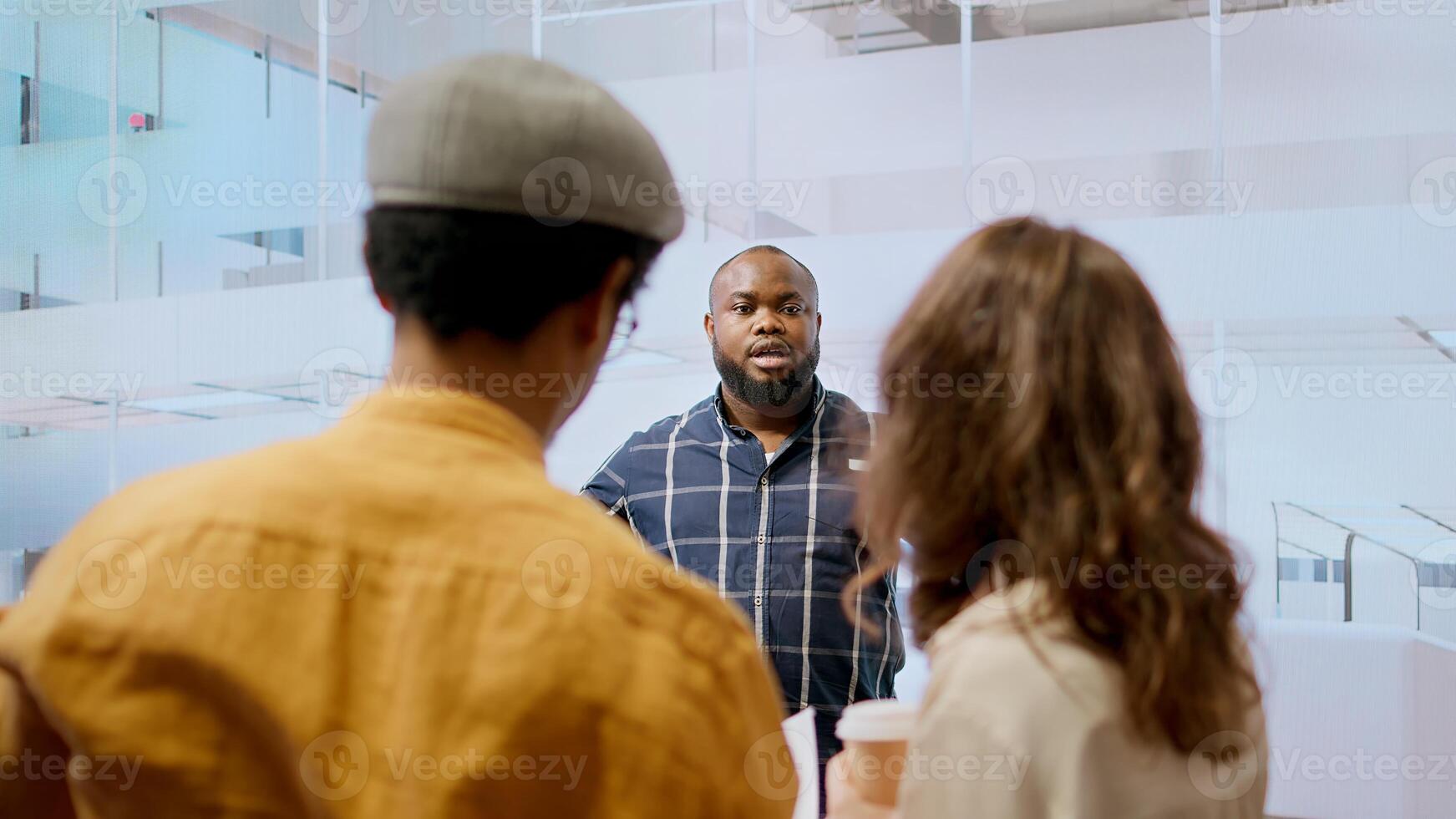 Real estate advisor discussing a promising property deal with potential corporate clients, examining blueprints and planning architectural layout of modern office space. Consider renting. Camera A. photo