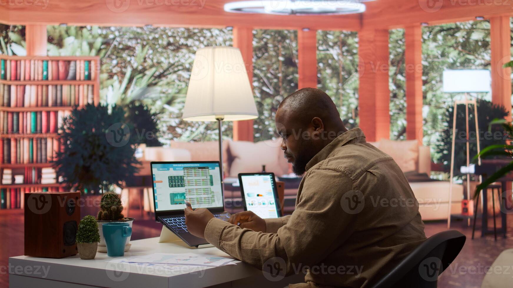 Entrepreneur using a card to make an online shopping payment via electronic banking, purchasing things to help the startup activity. Business owner makes a payment at his home office. Camera B. photo