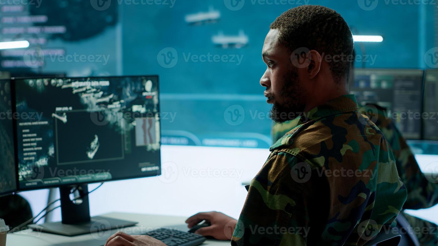 Team of military specialists overseeing surveillance activity by using a cctv footage and radar, pointing at a big screen and world map. High tech control center base of operations. Camera A. photo