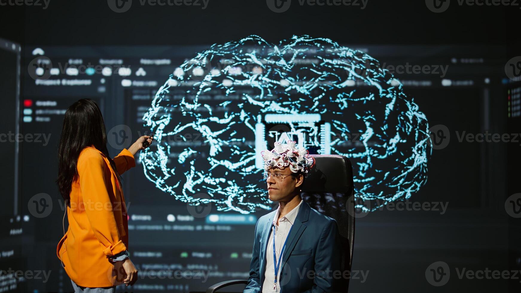 Company CEO using summit as platform to launch latest AI EEG headset product. Neuroscientist doing demonstration at forum in front of business leaders interested in artificial intelligence, camera B photo