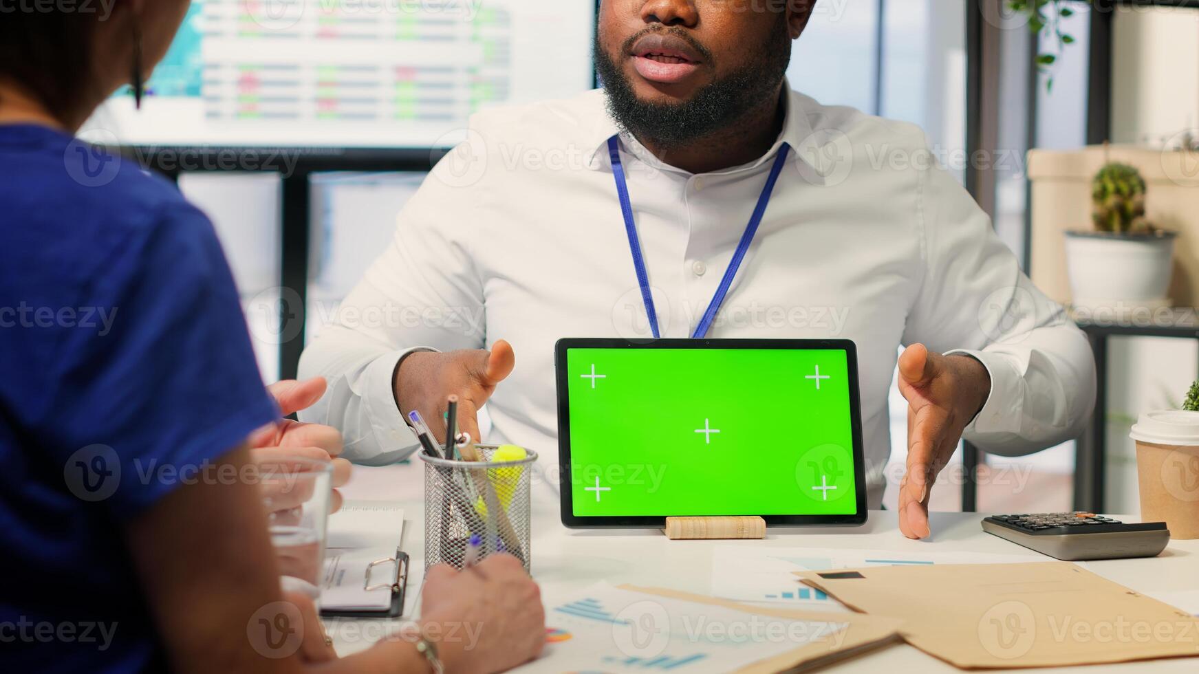 Financial advisor works with a green screen at table with his senior clients, presenting retirement plans and investment options to secure their pension and life savings. Insurance agency. Camera A. photo