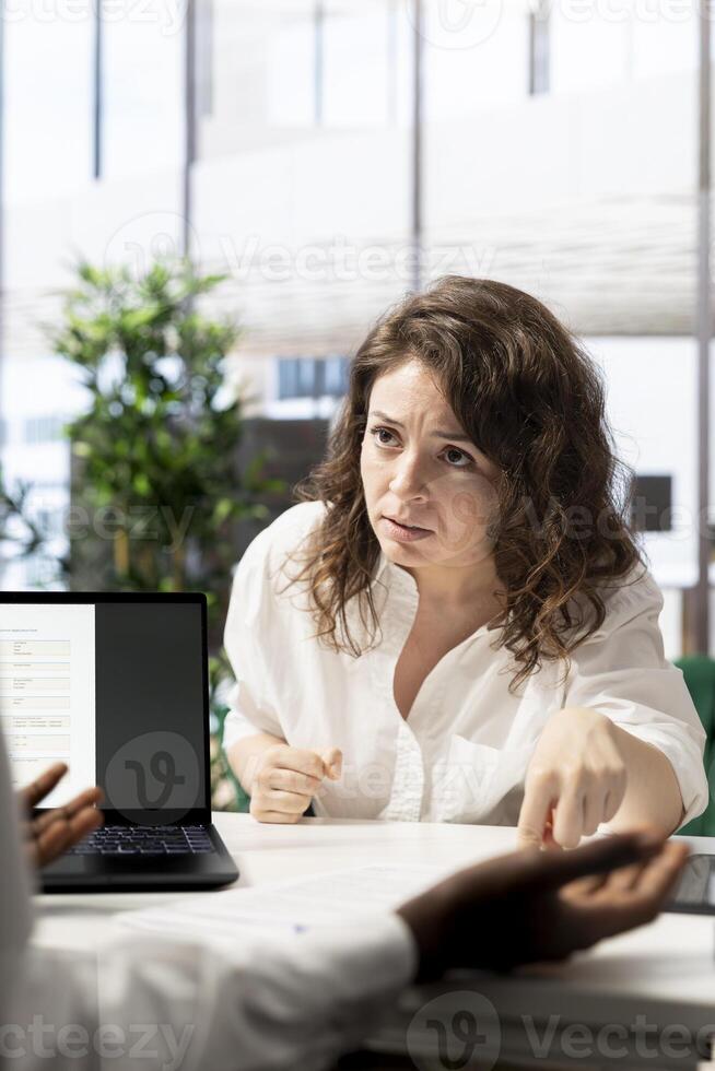 Woman feeling upset after not being selected by HR expert vetting applicants, ensuring their skills match role needs. Lady disappointed by headhunter not hiring her after assessing her work experience photo