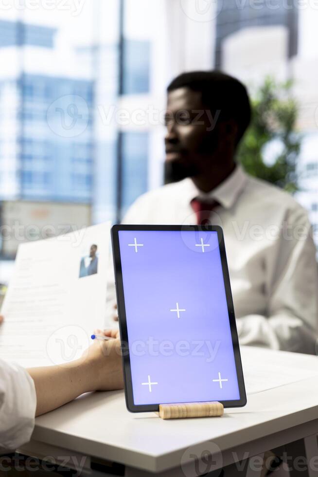HR specialist using isolated screen tablet to reviewing candidate CV, asking questions about qualifications. Person getting hired by recruiter using mockup device after proving skills for job photo