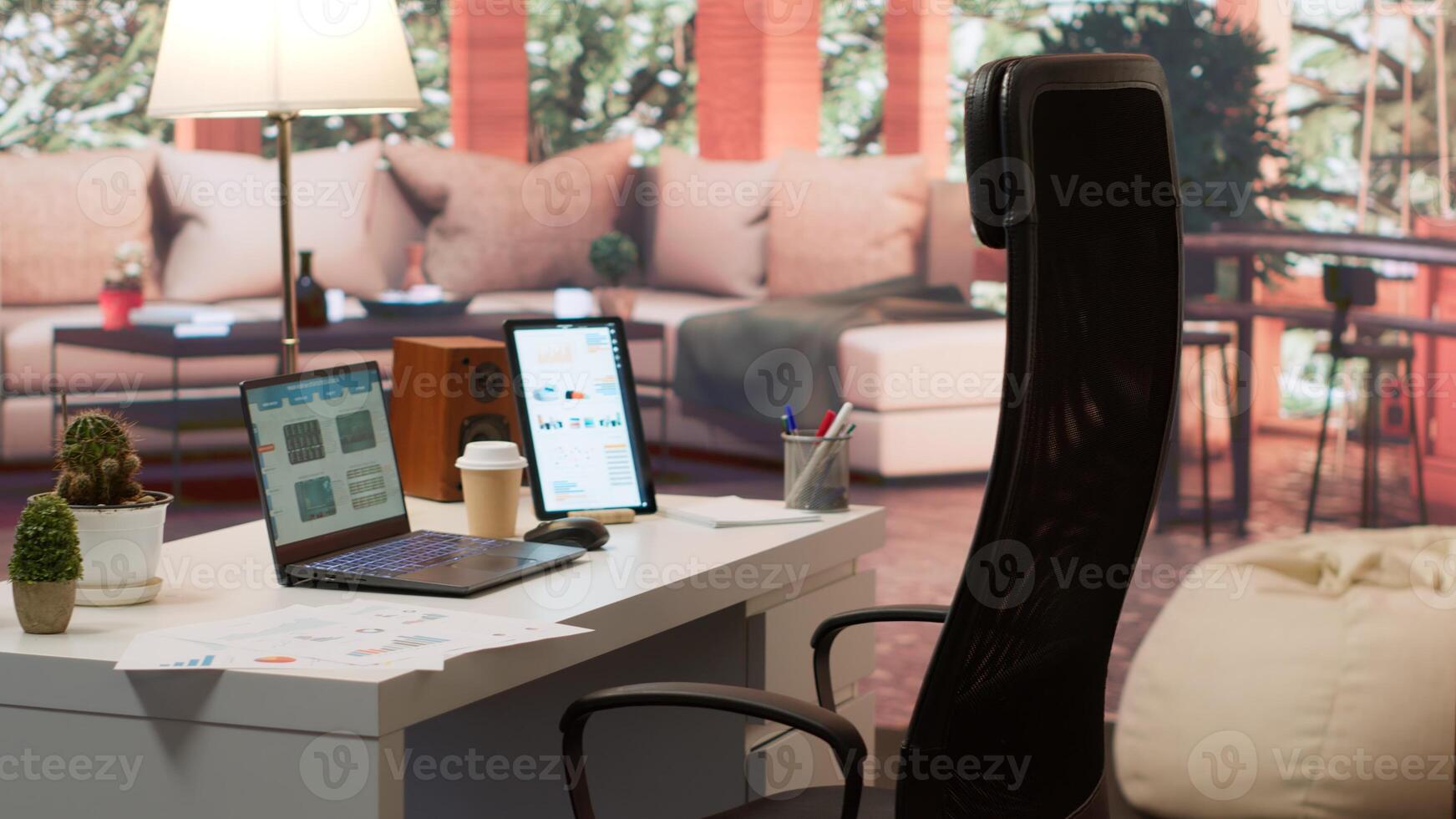 Empty modern home workstation of an entrepreneur with laptop and tablet, financial analytics data studied for startup investment and development. Remote job in business industry. photo
