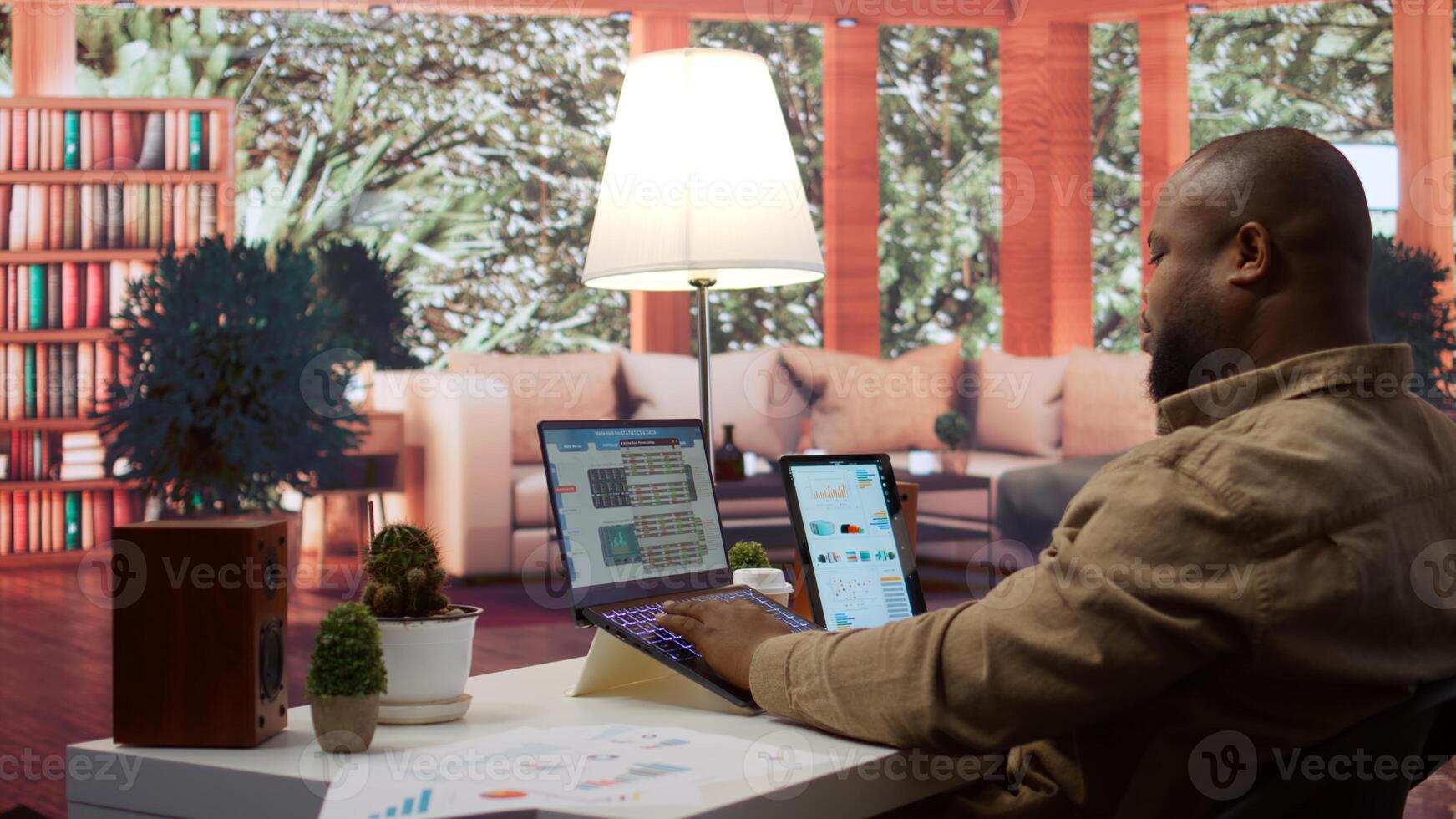 Entrepreneur calculating expenses with online invoices on laptop, creating an analytics reports plan for investment strategy. Working on increasing budget for business expansion. Camera B. photo