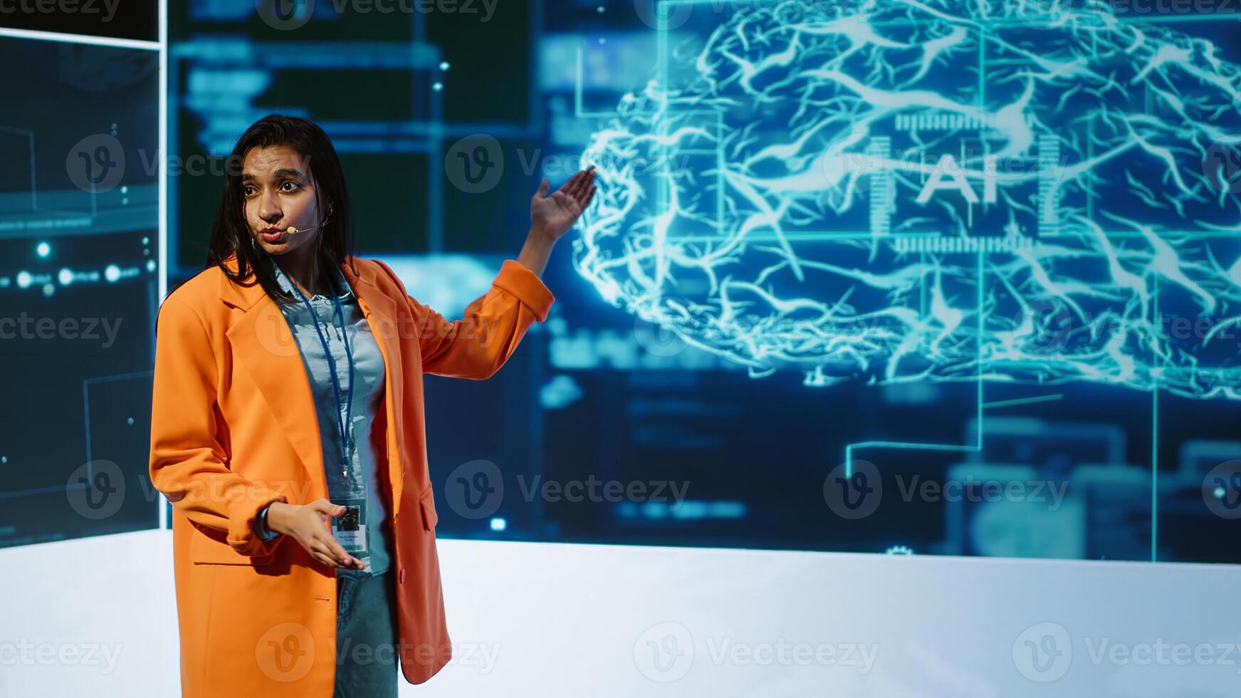 Speaker talking on stage in event bringing together leading experts, researchers, innovators and companies from around the globe to explore latest developments in AI and machine learning, camera A photo