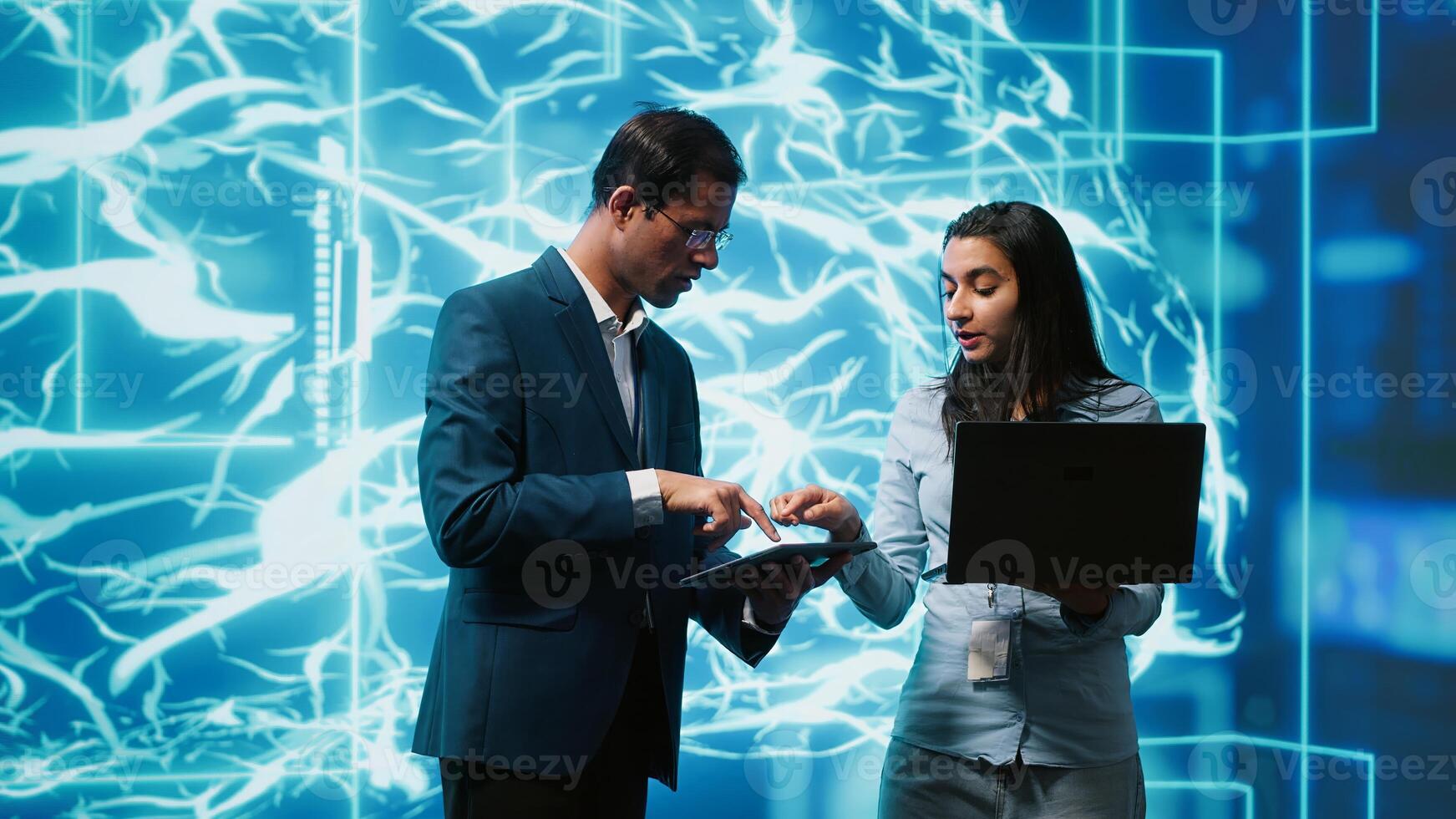 Coworkers using AI neural networks modeled after human brain, brainstorming ways to solve complex problems. IT department staff members using deep learning to look at data and complete tasks, camera A photo