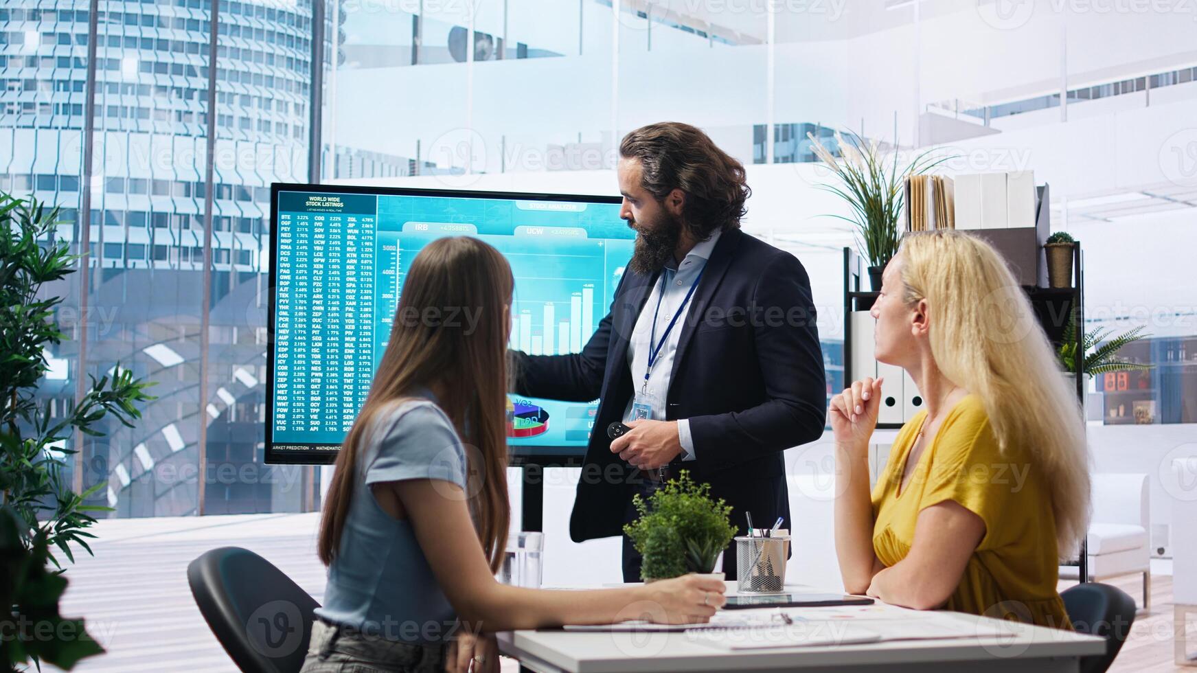 Financial adviser presents market analytics to customers using large display, emphasizing data driven decision making. Broker agent showing statistical graphs about stock exchange shares, camera A photo