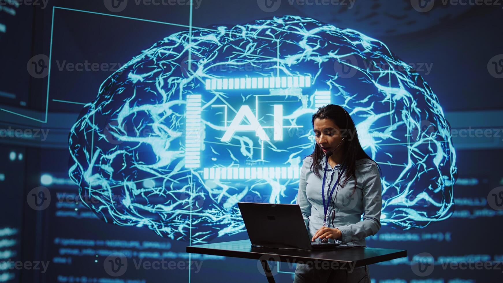 Technician in high tech workspace managing call center tasks, speaking into headset while doing monitoring with laptop. AI company employee talking with clients through headphones mic, camera B photo