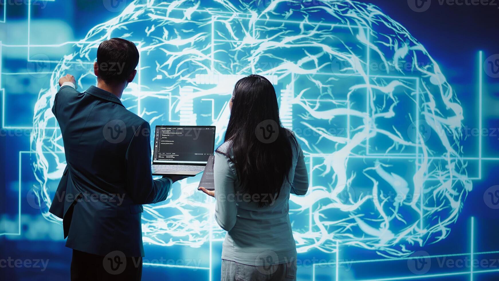 Coworkers doing brainstorming, using devices to fix artificial intelligence neural networks. High tech workspace colleagues using AI system aiding in processing and transmitting information, camera B photo