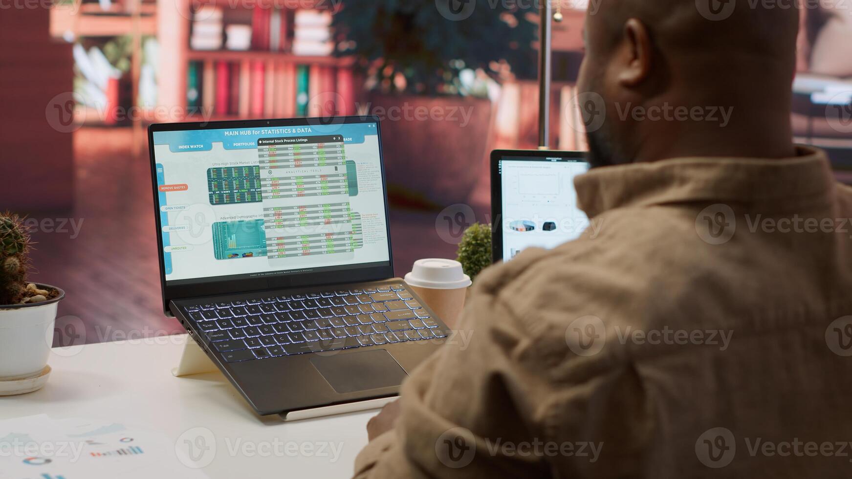 Entrepreneur calculating expenses with online invoices on laptop, creating an analytics reports plan for investment strategy. Working on increasing budget for business expansion. Camera A. photo