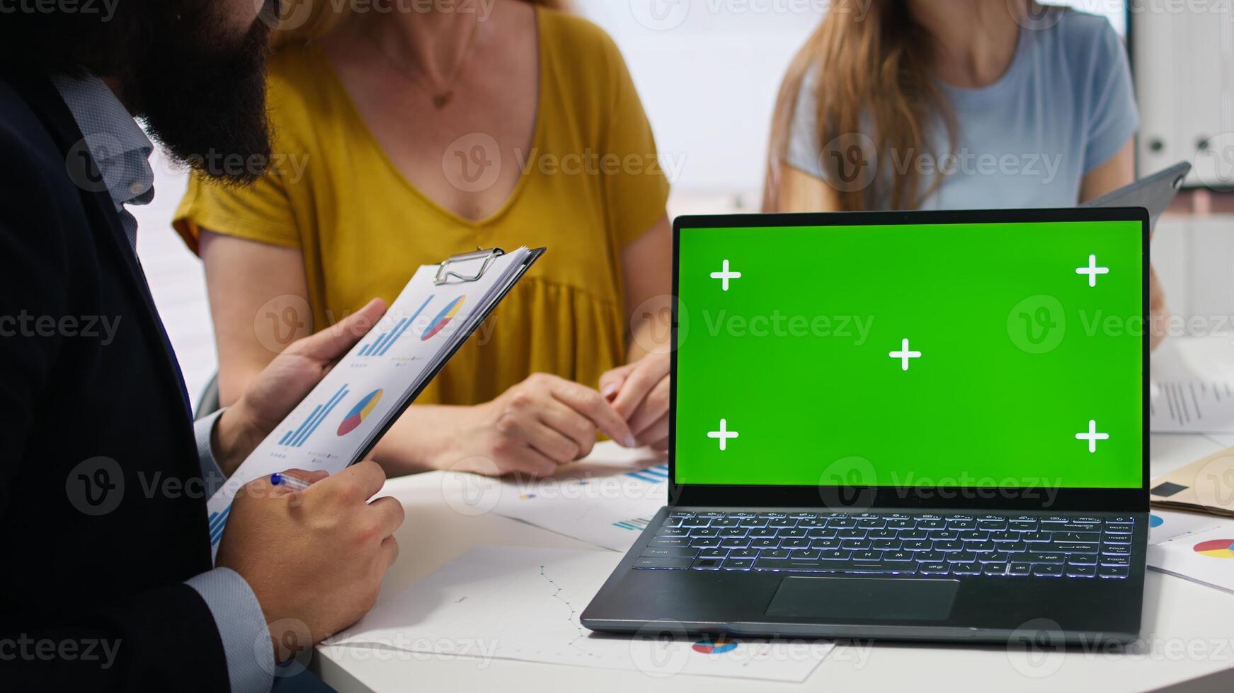 Clients looking over personalized planning guide on green screen laptop written by financial advisor during meeting. Consultant optimizing living expenses for customers using mockup notebook, camera A photo