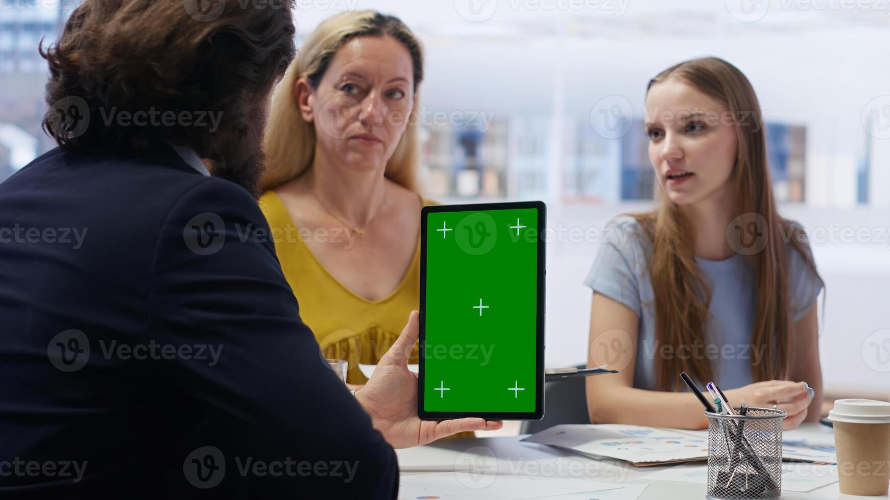 People receiving personalized financial plan from financial advisor using isolated screen tablet. Customers learn how to make profitable decisions from agent using chroma key device, camera B photo