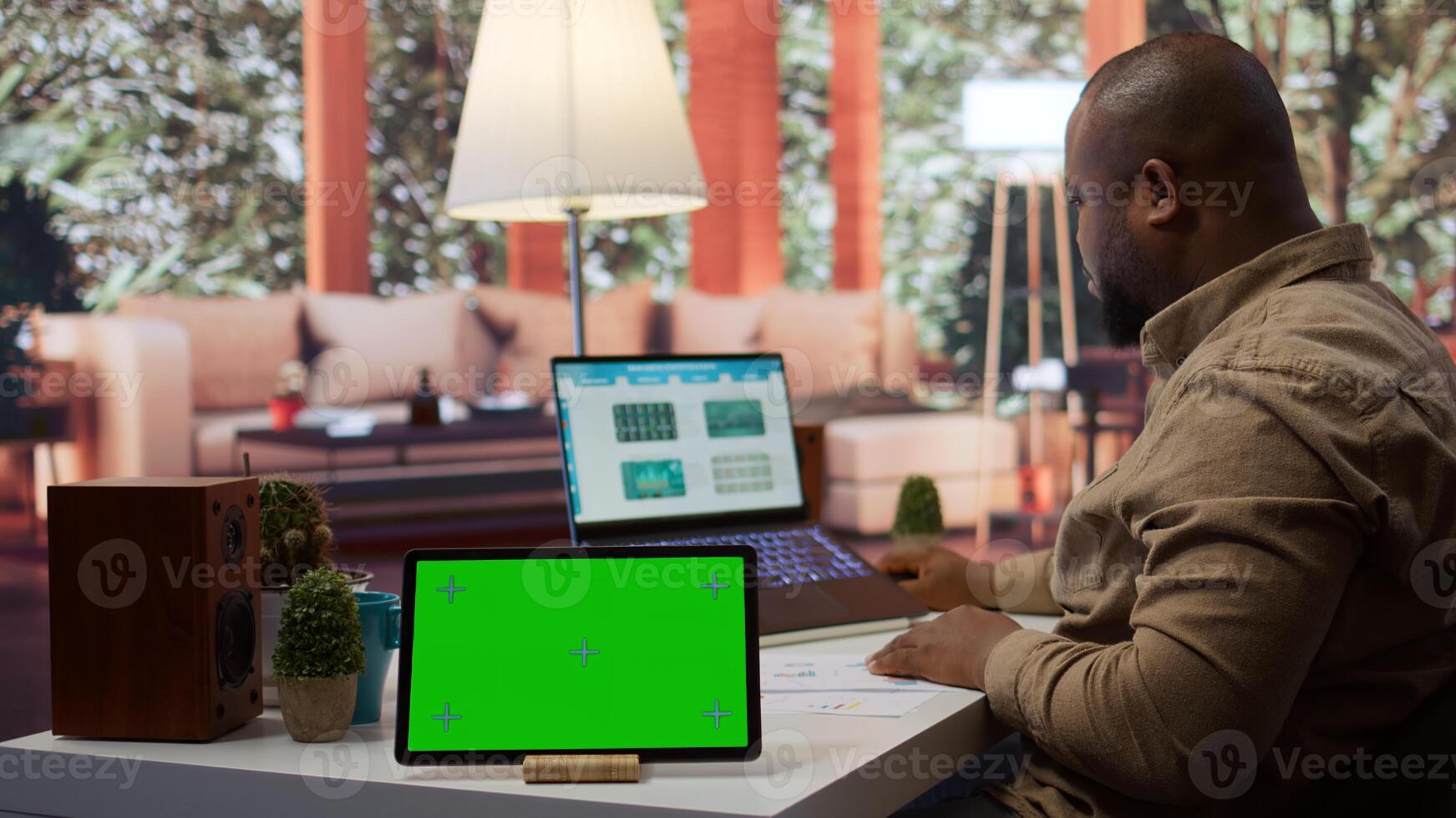 Financial expert reviews business statistics next to a chroma key screen, analyzing budget balance to ensure a correct economic situation report. Entrepreneur examines data analytics. Camera B. photo