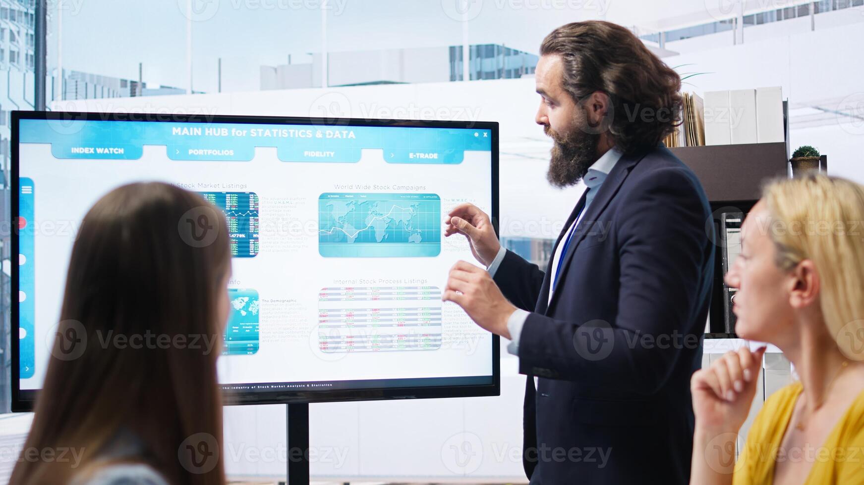 Team leader in company financial department showing stock portfolio on big screen containing collection of investment assets. Businessman showing stock demand surge in large display, camera A photo