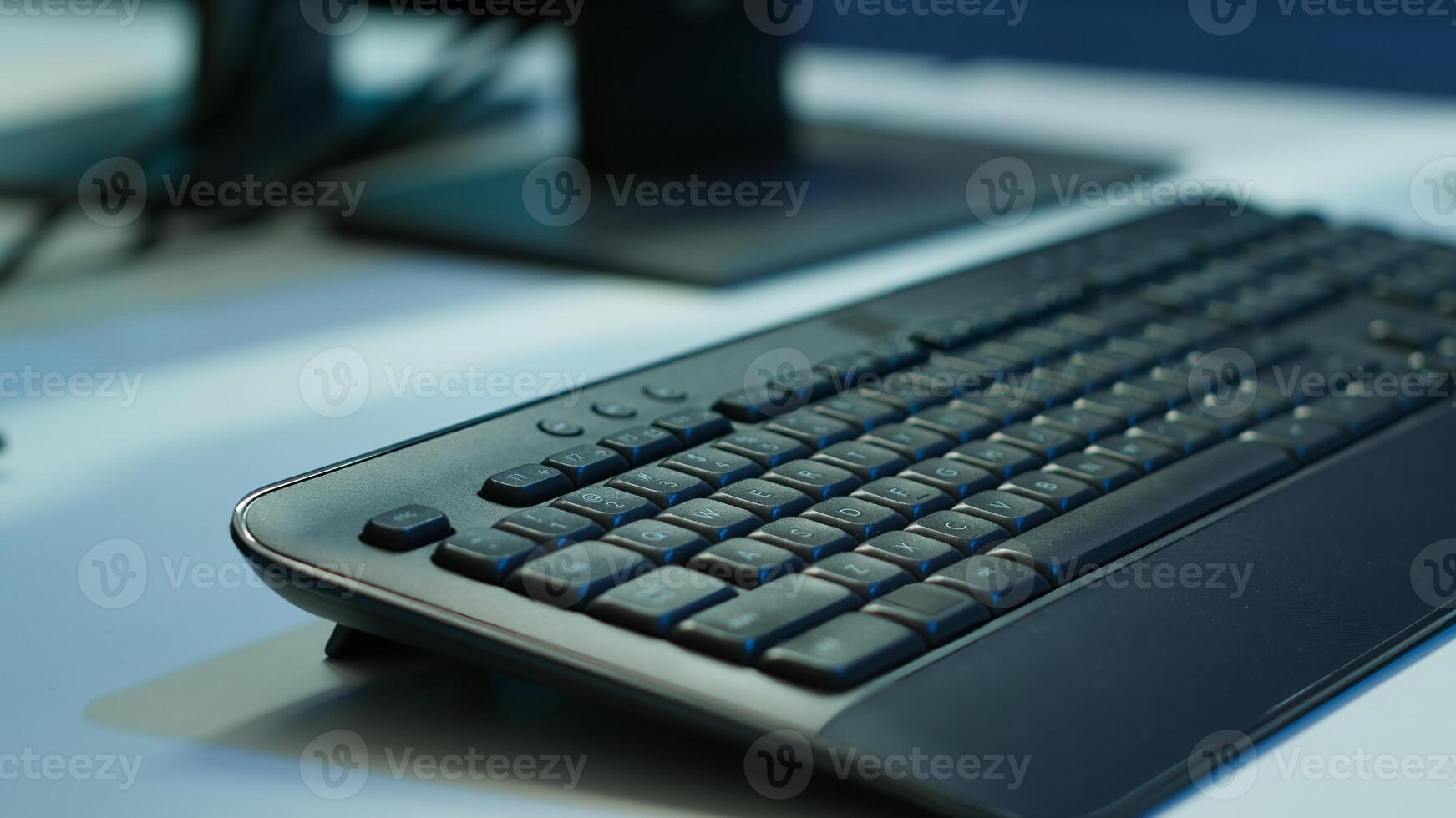 Extreme close up shot of computer displays on desk in server farm used for overseeing equipment. Monitors in data center facility with networking systems installed used for managing rigs photo