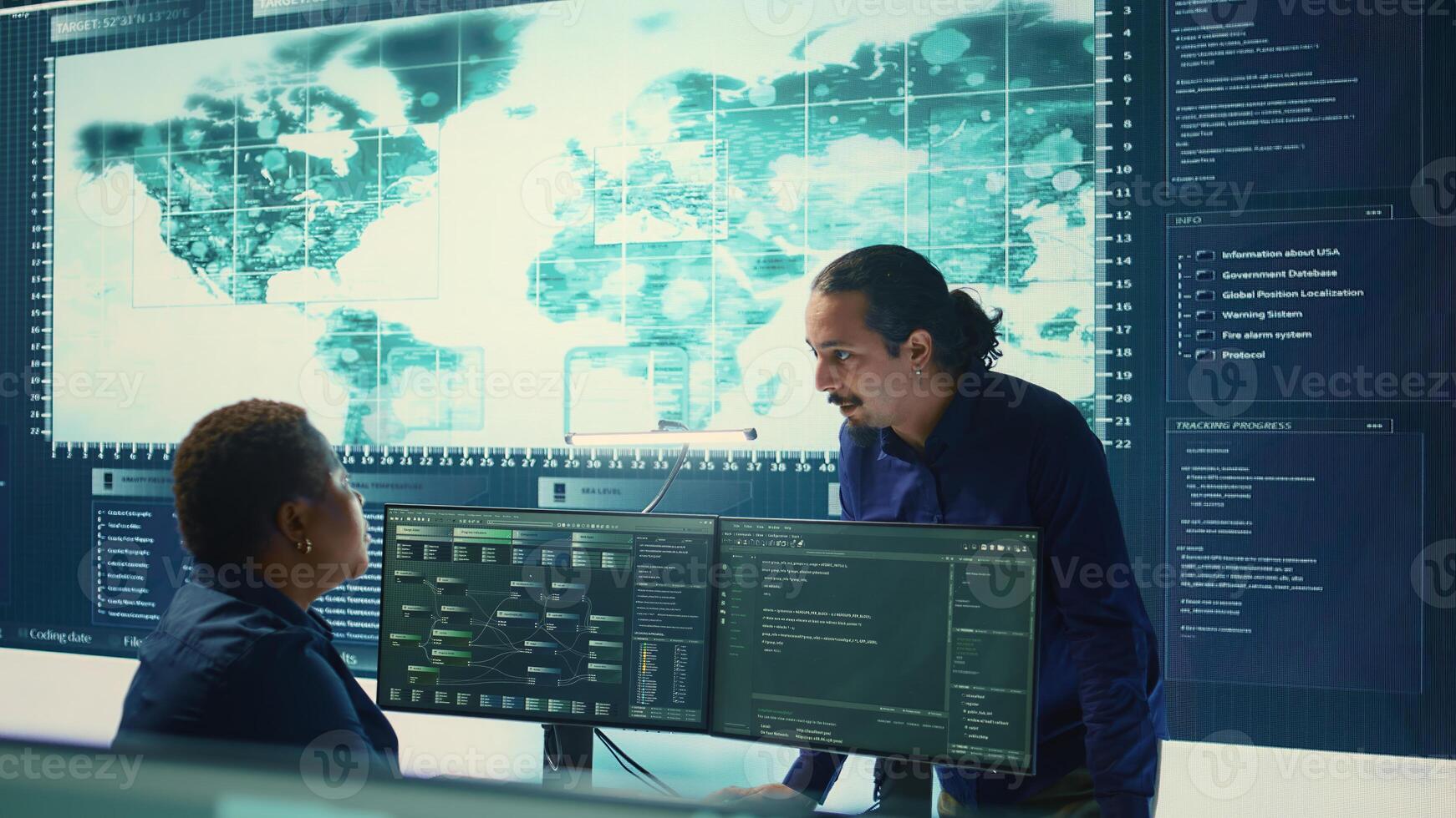 Cyber defense team working in a governmental security operations center. Experts ensuring cybercrime prevention and data breach protection, examining information on a big screen. Camera B. photo