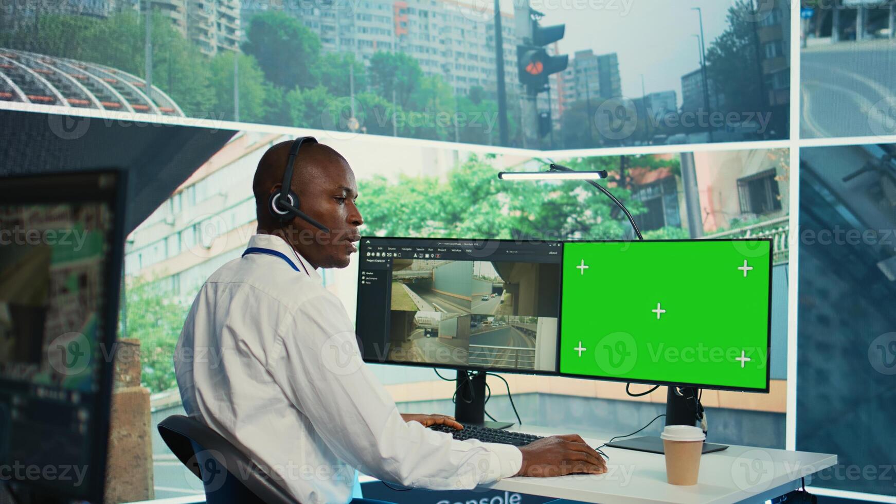 African american agency worker using CCTV footage and isolated display, monitoring traffic through real time surveillance in observation room. Employee works within the government. Camera B. photo