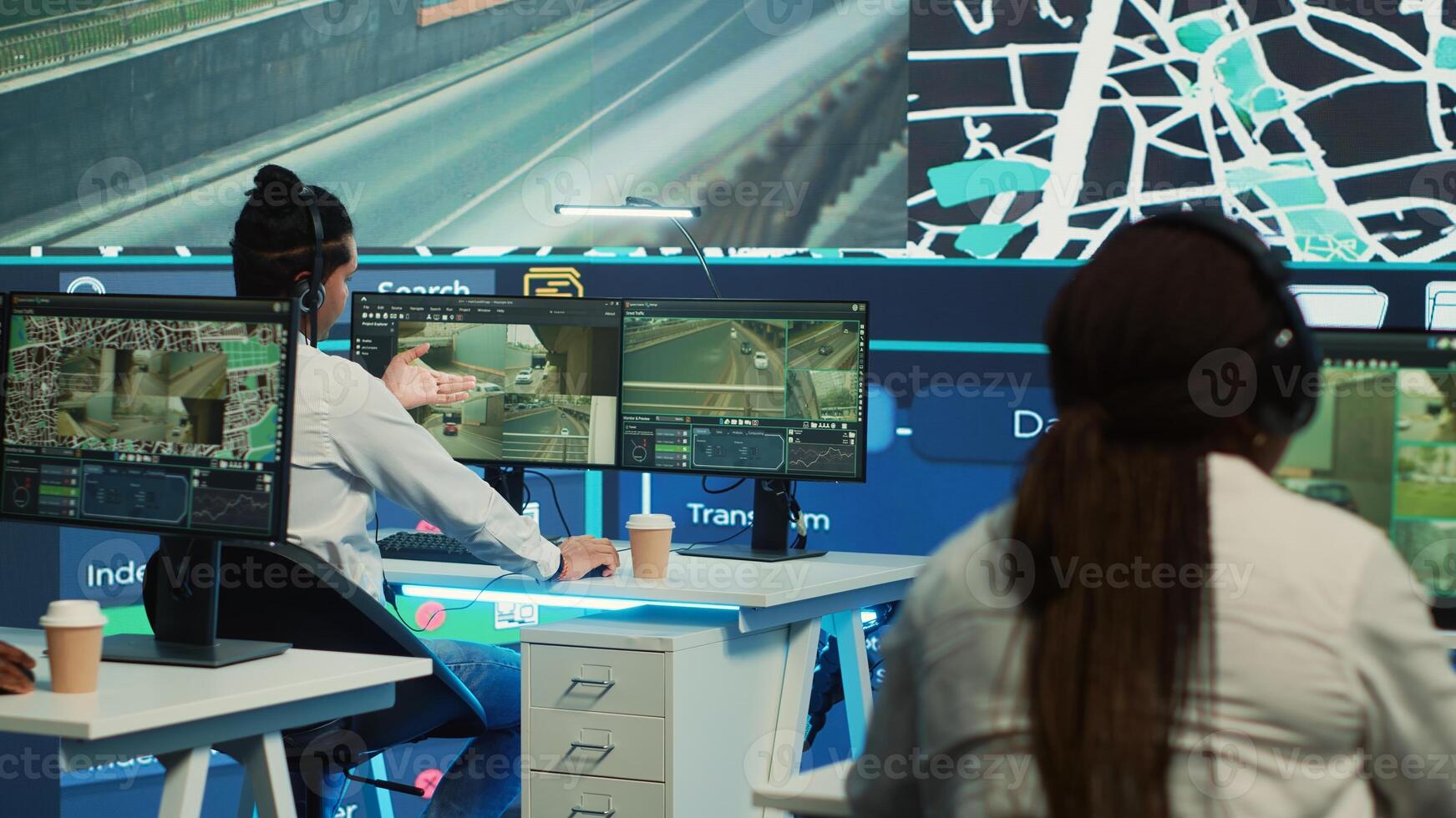 Call center operators providing shipment information via gps satellite map for their clients, ensuring fast delivery. Employees locating their drivers with coordinates, monitoring traffic. Camera A. photo