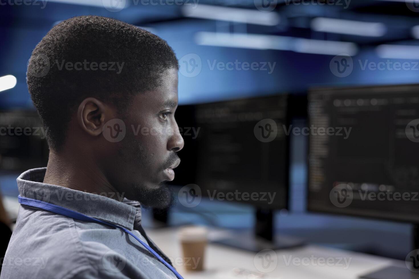 Engineer doing maintenance in data center facility to extend equipment life span and avoid downtime. Close up shot of IT expert monitoring servers for issues such as overheating or power fluctuations photo