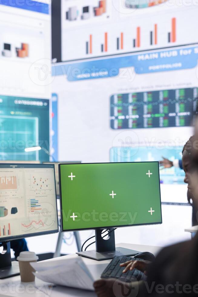 Enterprise worker examining annual sales statistics next to green screen, learning what to improve for business international development. Analyst reviewing key performance indicators. photo