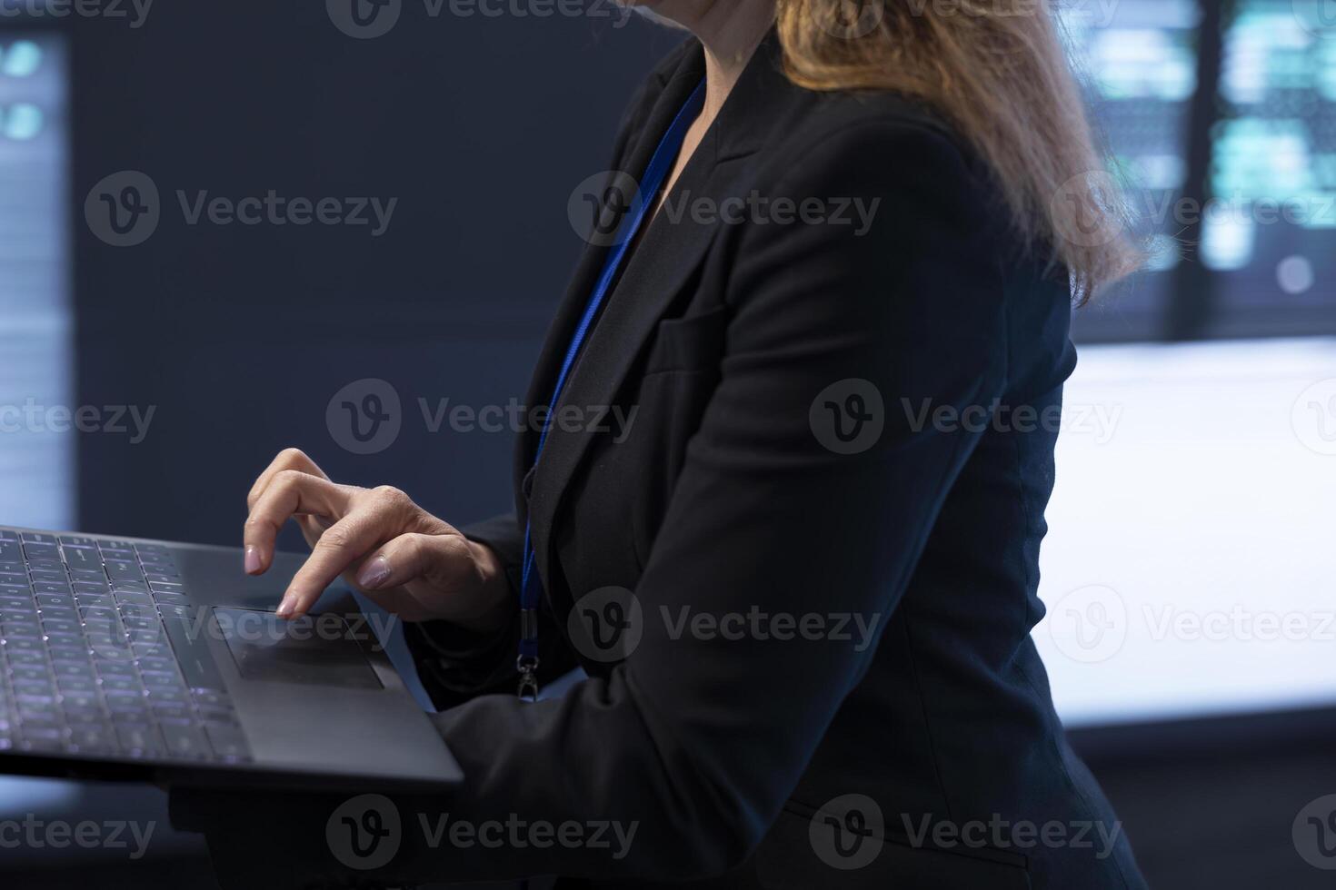Computer scientist in server room using laptop to implement and maintain security measures, protecting systems from unauthorized access. Close up of data center worker doing hardware upgrades photo