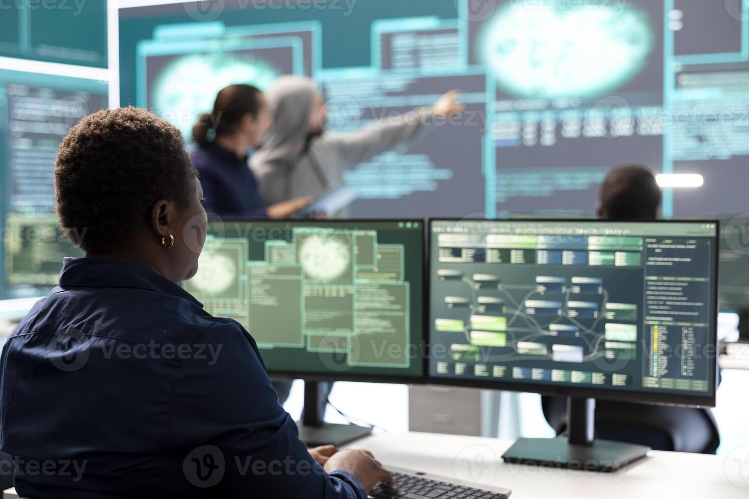 Woman governmental hacker analyzing digital threats on a computer, working in professional agency with a big screen. Specialist collecting information, fighting against cyberterrorism. photo