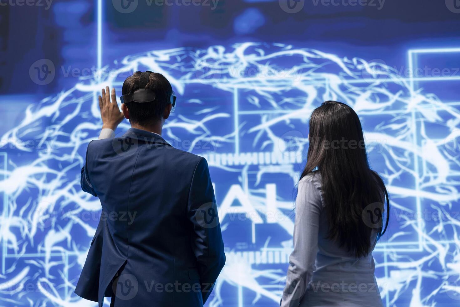 Engineers use VR headset and AI neural networks modeled after human brain to solve complex problems. IT experts using artificial intelligence and virtual reality tech to look at data photo