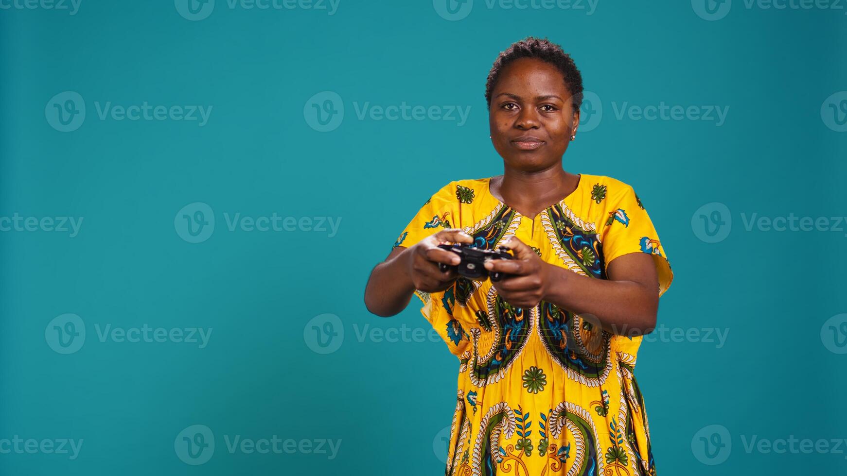 Optimistic confident woman playing videogames on console in studio, having fun with online e sport tournament with a controller. Young gamer enjoys gaming for leisure and relaxation. Camera B. photo
