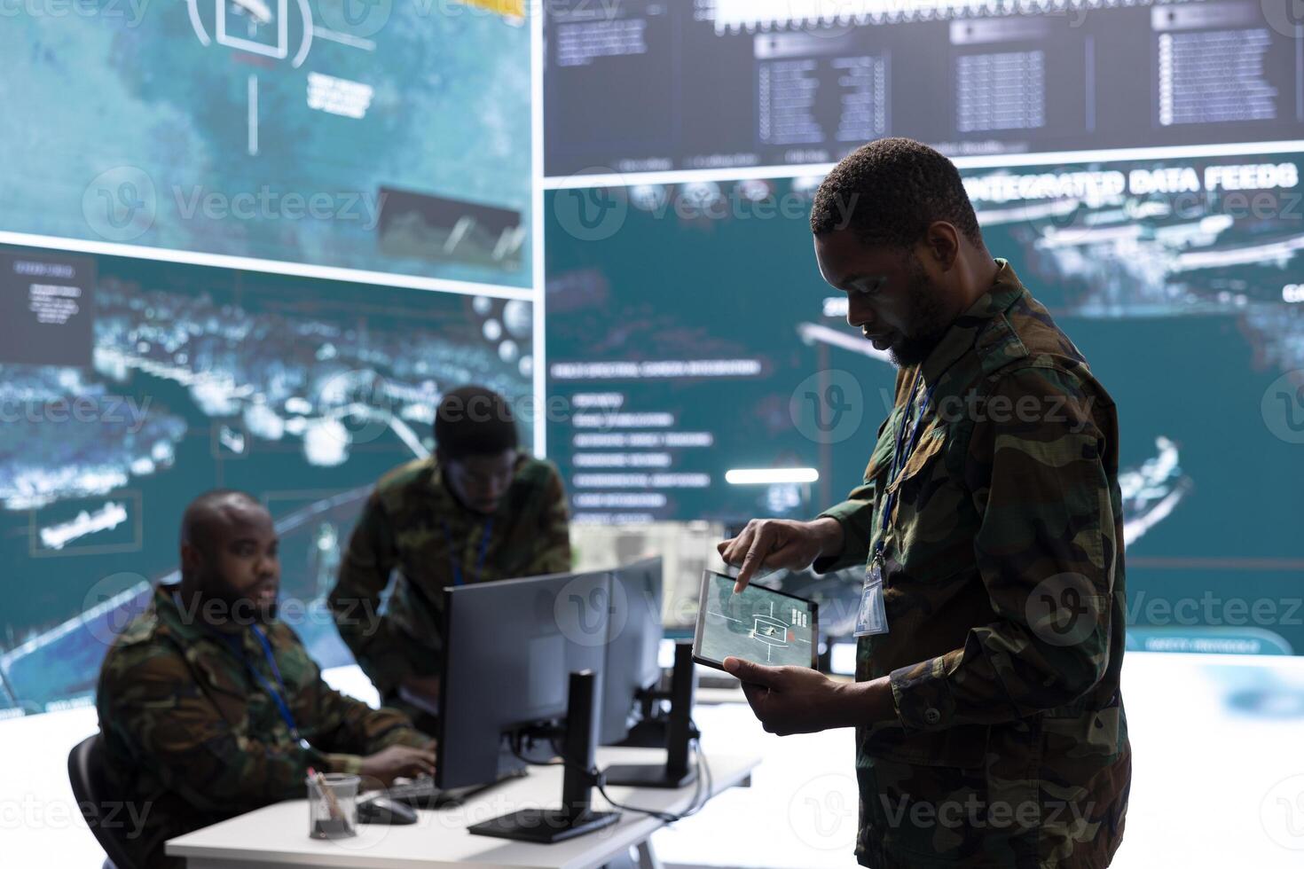 Military team in a control center uses advanced technology to gather crucial information, satellite surveillance systems to support strategic planning. Monitoring potential threats on big screen. photo