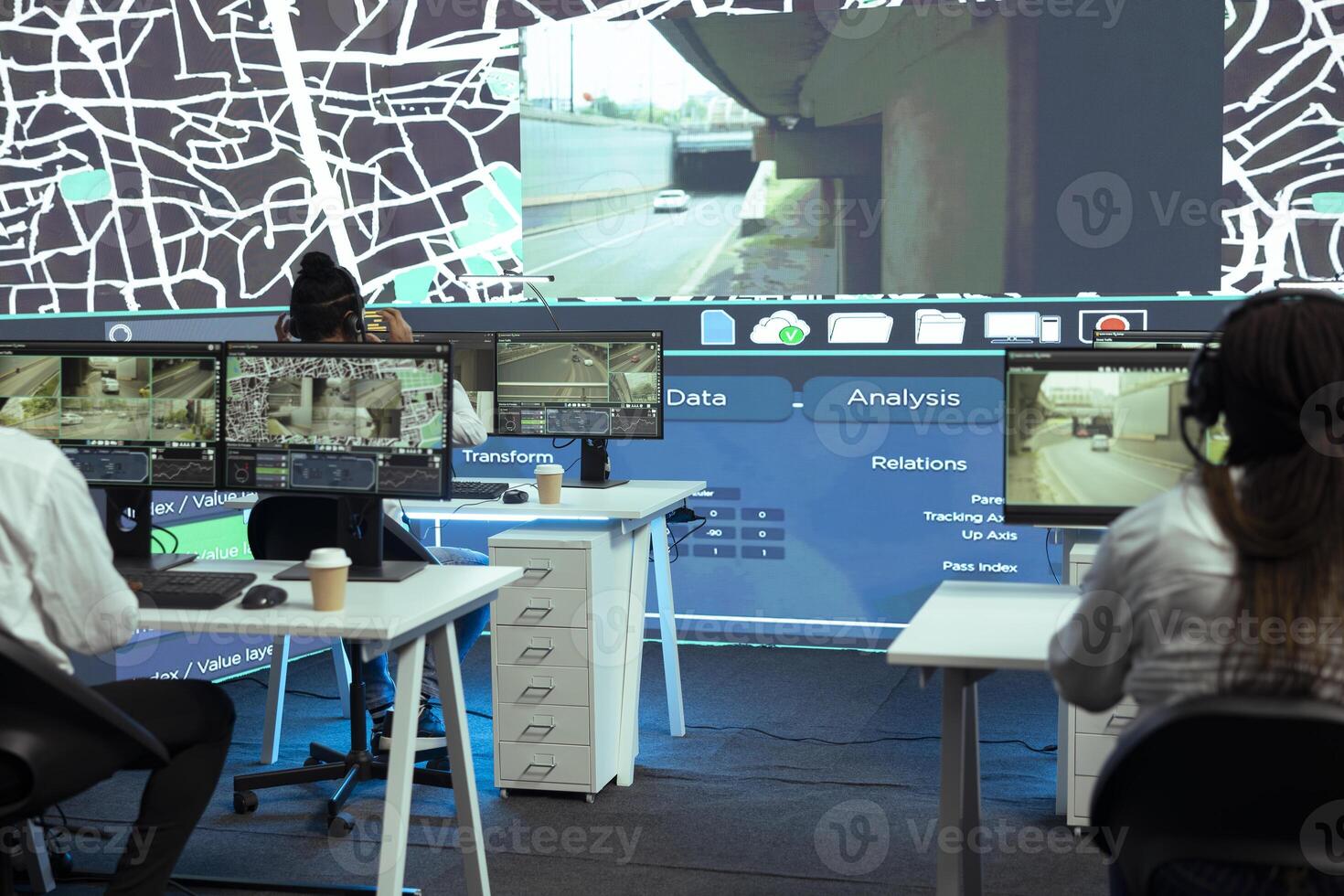 Shipping agency employees monitoring their cars and couriers to ensure express delivery using the best routes through the city. Diverse team tracing their drivers with gps satellite map. photo