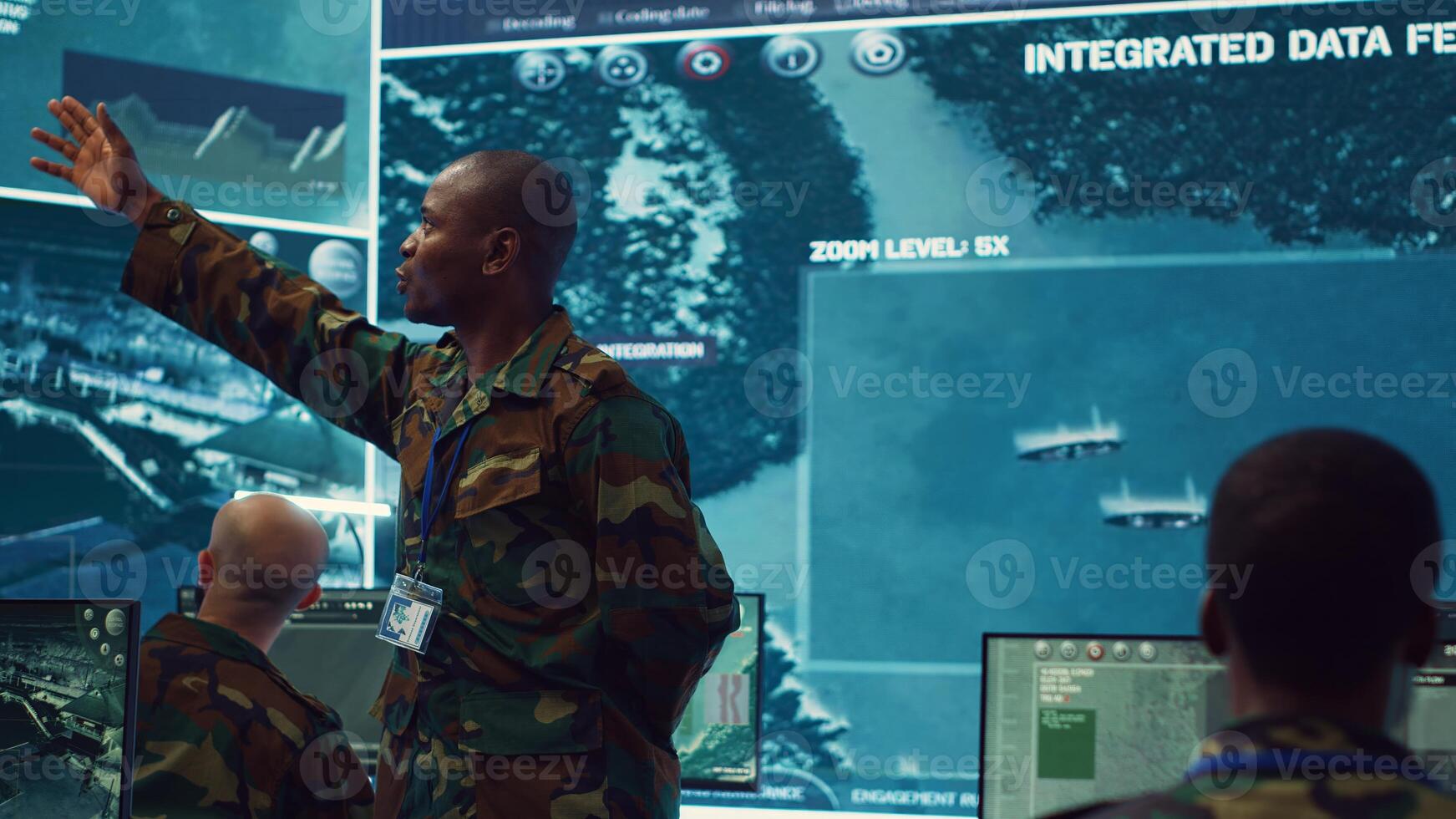 Major general updating and maintain the command center databases with current operational data, monitoring surveillance radar footage to ensure national safety. Control room. Camera A. photo