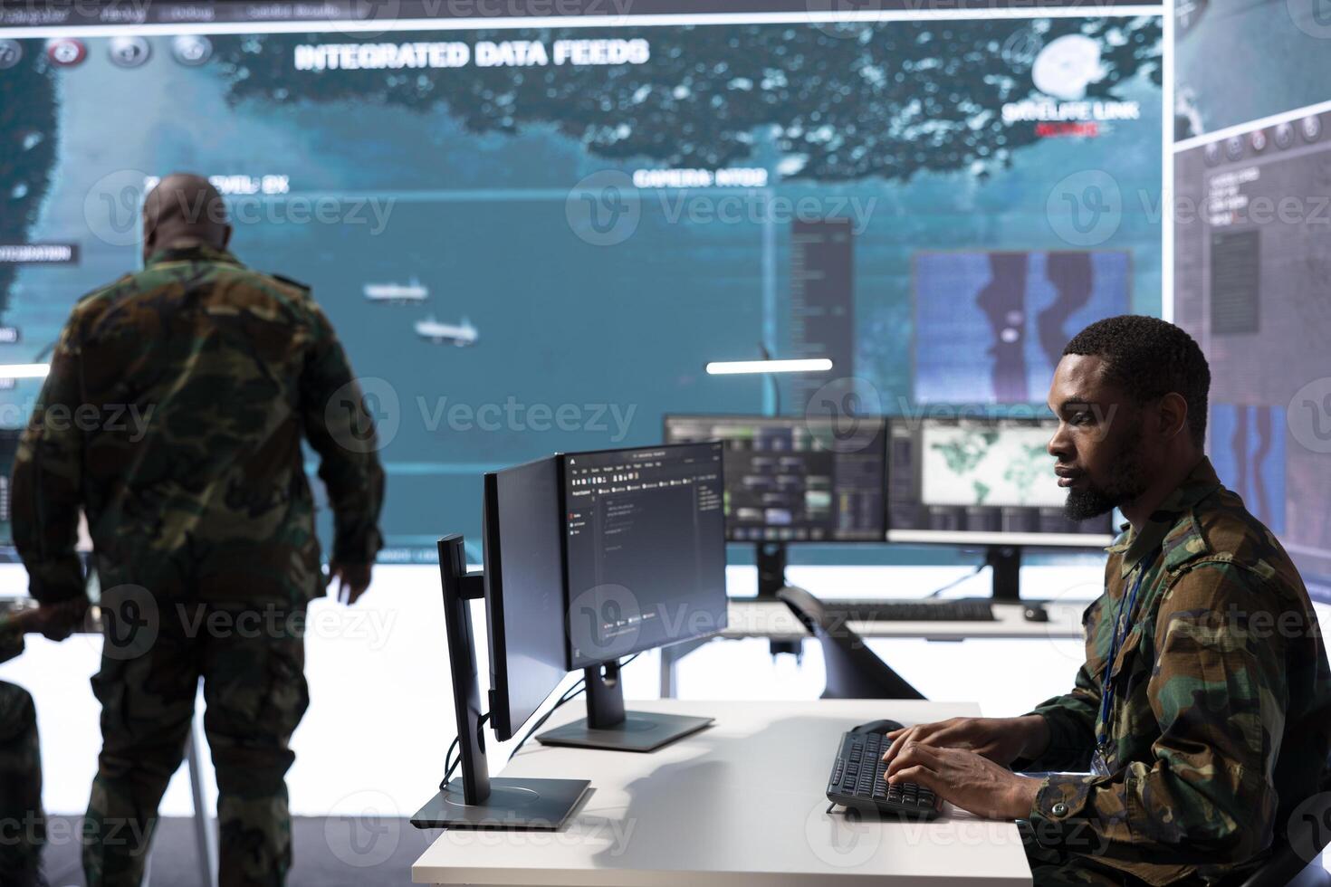 Military crew in a high tech operations command post managing information collected from radar cctv systems, real time data to support defense missions. Army protocols for national security. photo