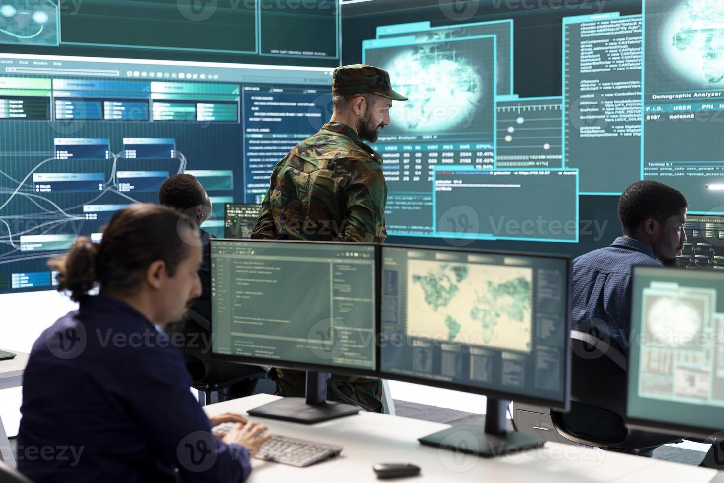 Military IT experts working on cyber security in a high tech government office. Focusing their duty on network protection, encryption and safeguarding state secrets from digital mercenaries. photo