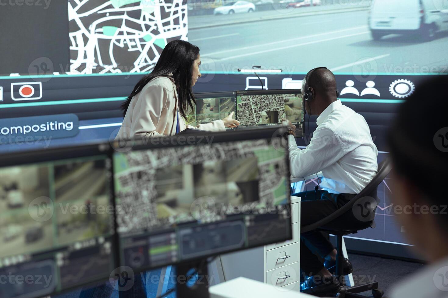 Indian team leader offers order logistics insight to her team in monitoring room, working on express delivery service. Employee consulting his manager about gps tracking intelligence. photo