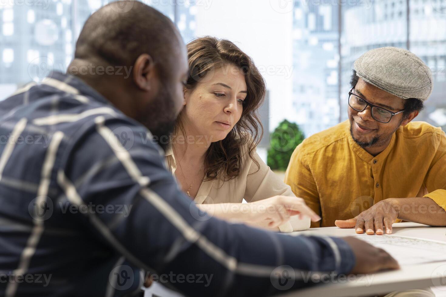 Corporate clients engage in a strategic planning session with a real estate agent, reviewing blueprints and discussing office space relocation to a modern urban building. Investment strategy. photo