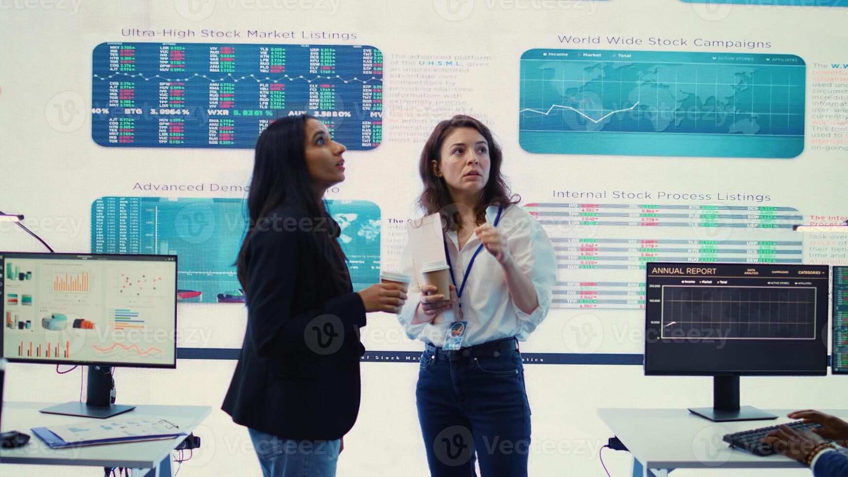 Managers collecting important statistics numbers on a big screen, reviewing sales and understanding the enterprise situation. Analyzing efficiency and workflow in goals achievement. Camera B. photo