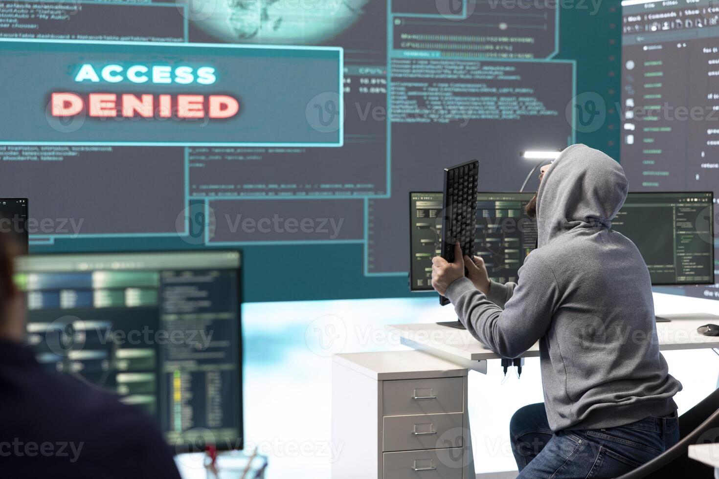 Displeased irritated team of hackers with denied access message on a big screen in governmental operations agency. Experts struggling to break into databases and steal server information. photo