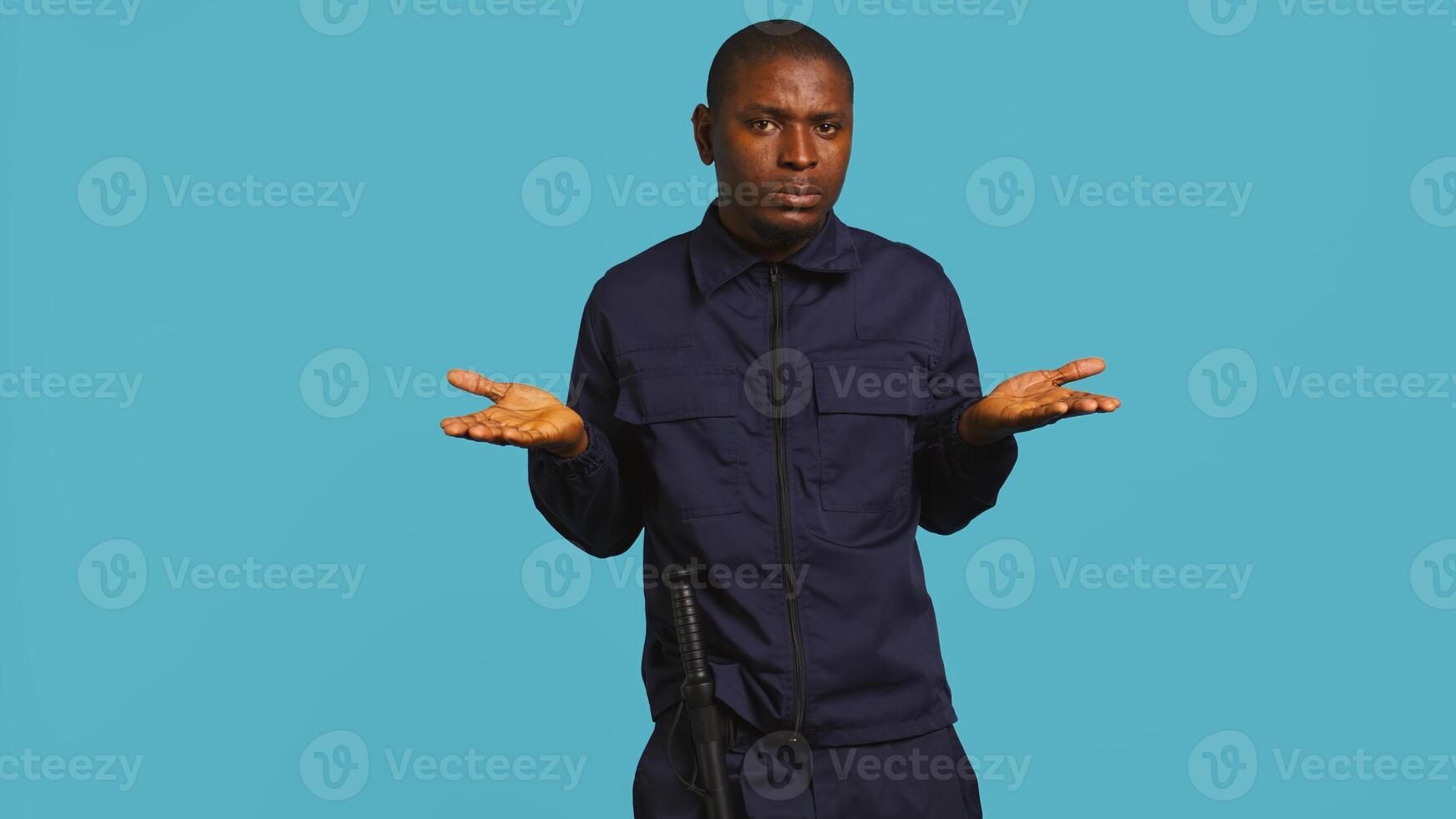 Clueless security guard shrugging shoulders, unable to answer people inquiries. Portrait of bodyguard doing lacking knowledge hand gesture, isolated over studio background, camera B photo