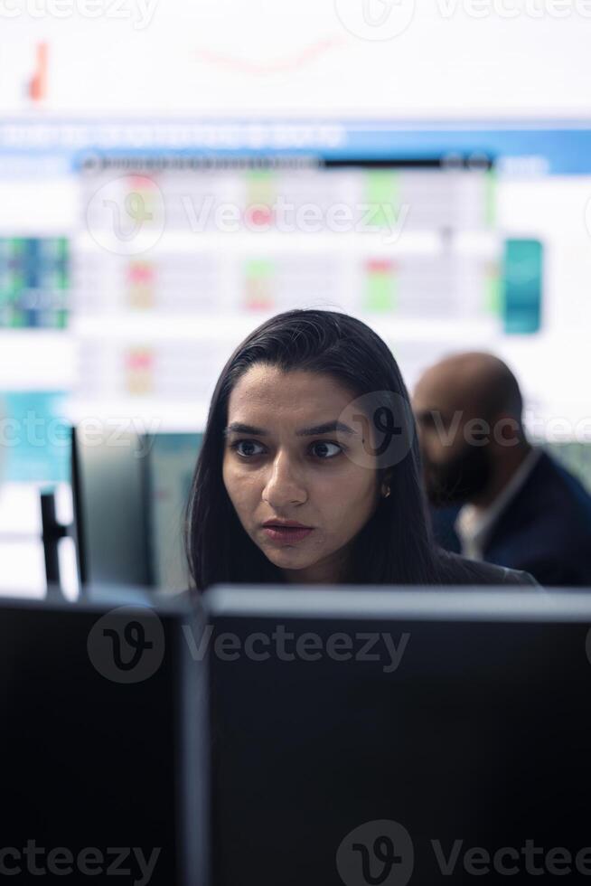 General manager working on data management with infographics and business activity reports, ensuring objective achievement. Shareholder reviewing an investment for global expansion. photo