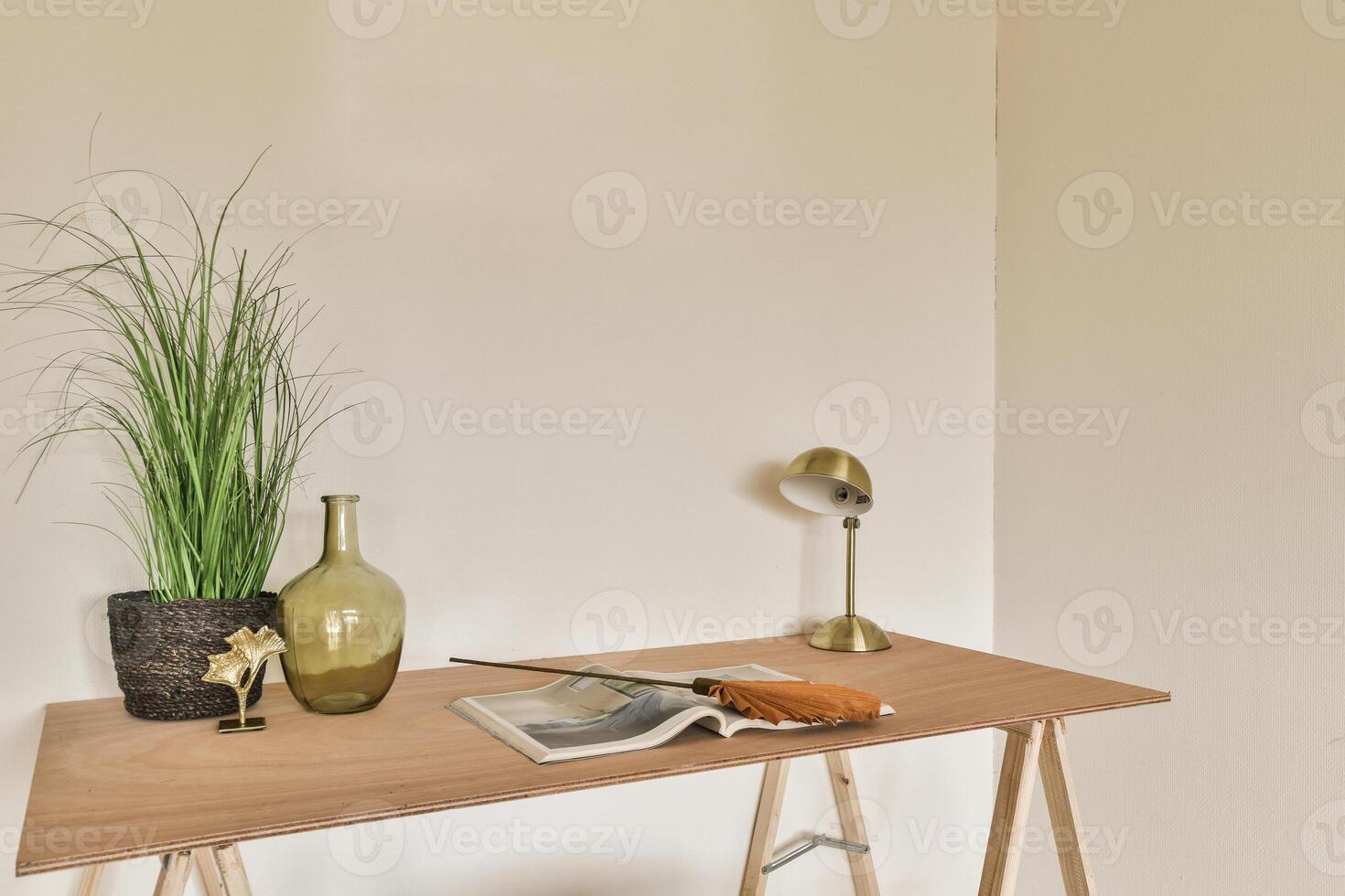 A desk with a plant on it and a book on it photo