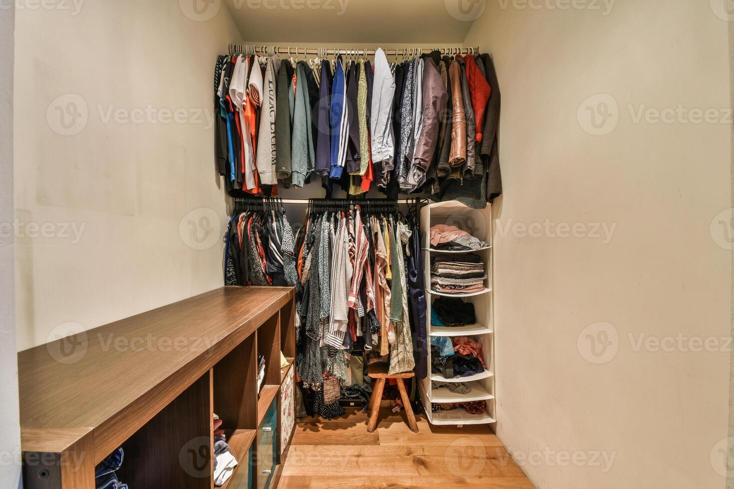 A closet with clothes and shoes on a shelf photo