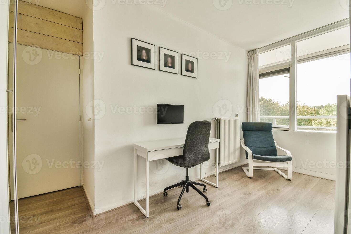 A small office with a desk and chair in front of a window photo