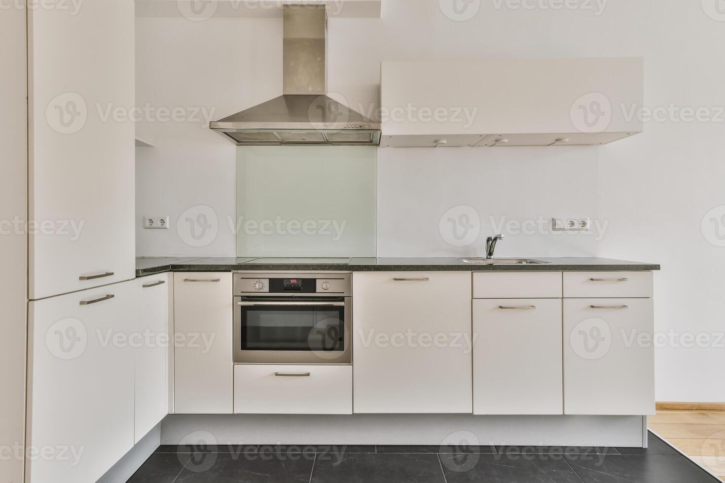 A kitchen with a stove and oven in it photo