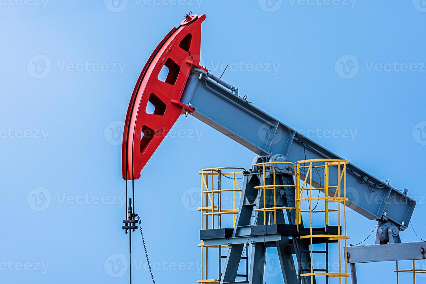 Oil drilling derrick pumps oil from ground. Petroleum industry, crude oil extraction. photo