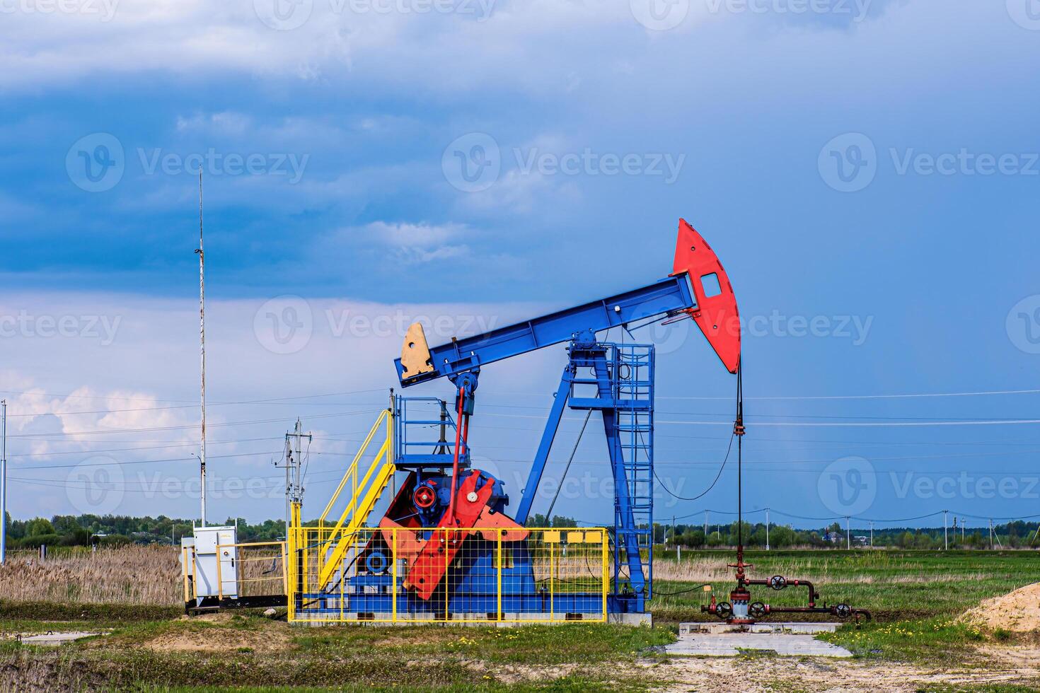 Oil drilling derrick pumps oil from ground. Petroleum industry, crude oil extraction. photo