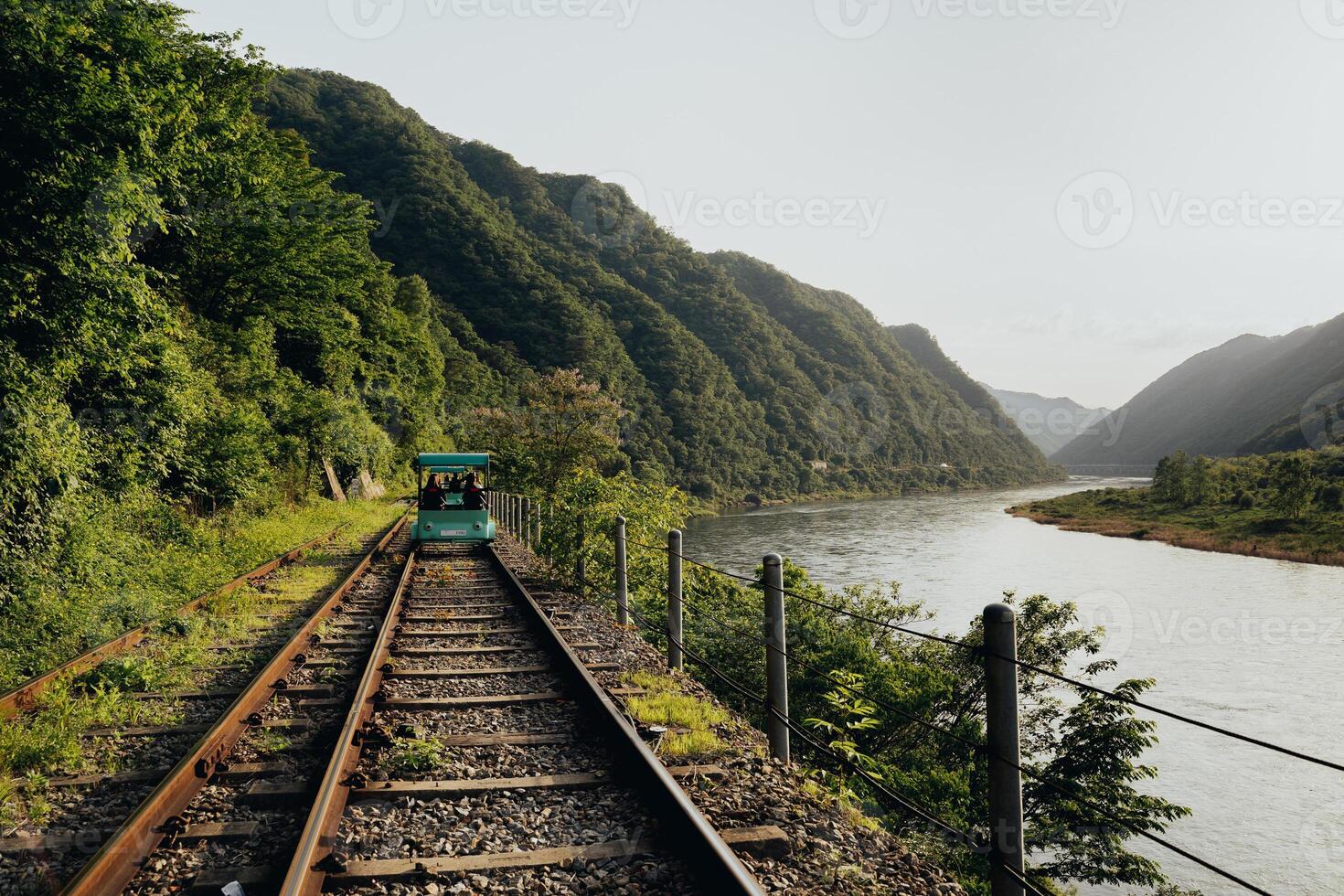Scenic Tram Rides on Overgrown Railway Tracks Surrounded by Beautiful Mountain Landscape Gangchon Rail Park photo