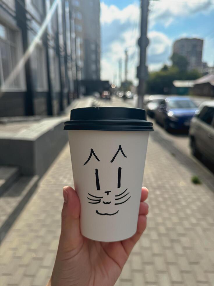 papper cup with a cute face on it, coffee to go photo