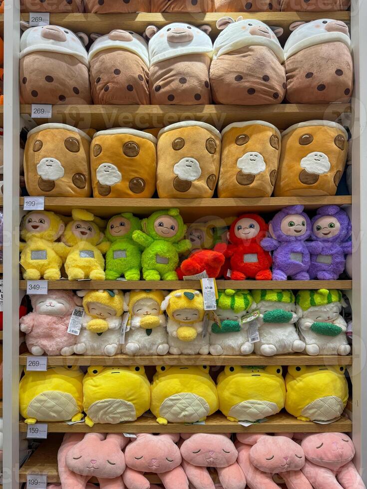 Soft toys on the shelves in a children's store for sale photo