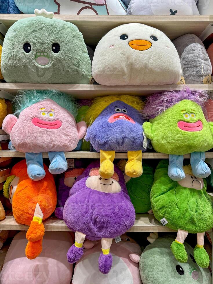 Soft toys on the shelves in a children's store for sale photo